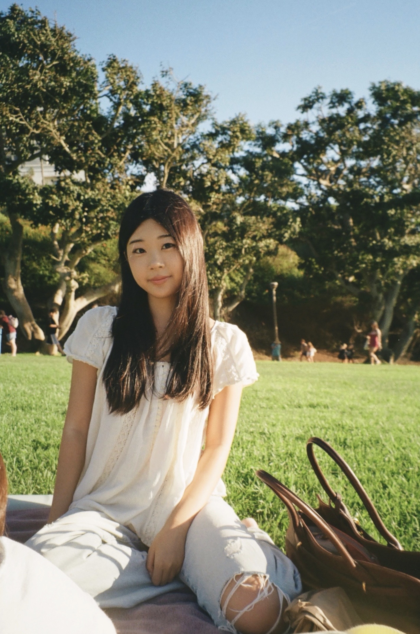 Photo of Chelsea sitting in a park